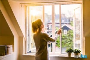 Een vrouw die Unilux horen sluit bij een boven raam | Worldwide home solutions